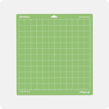 Green cutting mat with grid pattern on a white background