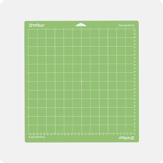 Green cutting mat with grid pattern on a white background