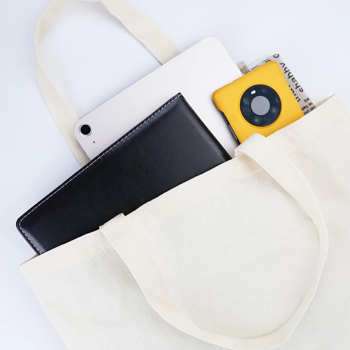White pouch with black phone case, yellow camera, and white phone inside on a light gray background